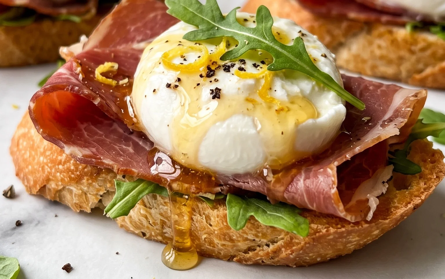 Beef Prosciutto Crostini with Burrata and Lemon Honey Drizzle